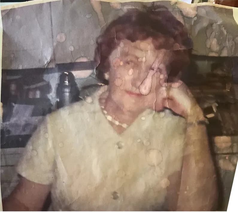 This discoloured photograph had faded and worn before restoration