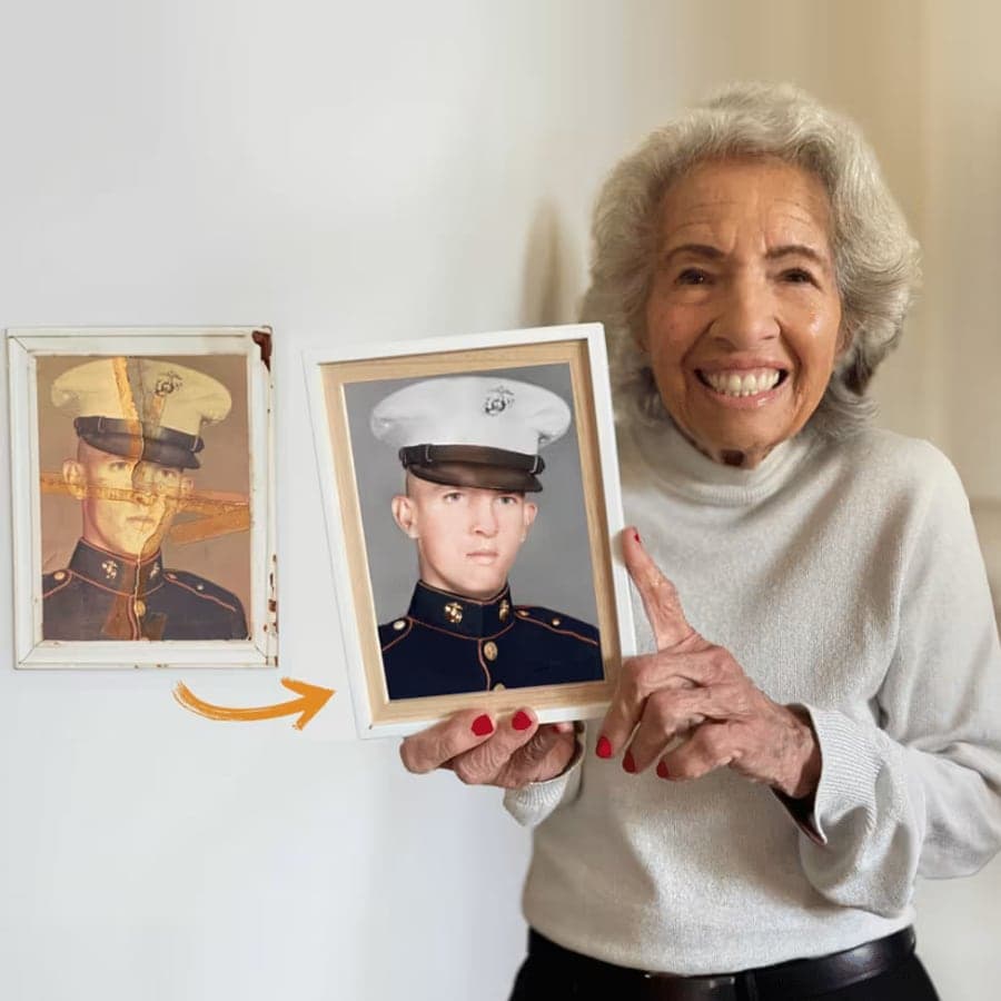 A customer holding her son's restored Marine portrait next to the damaged original on the wall